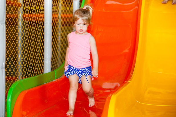 kid standing on slide